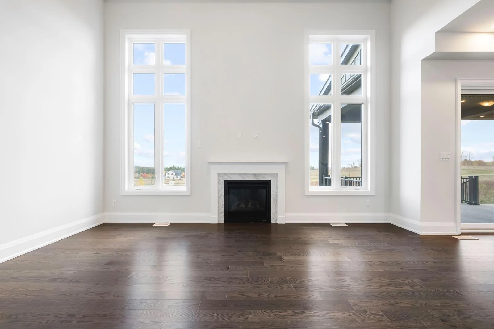 53 Holly Lane unfurnished living room with fireplace and tall windows