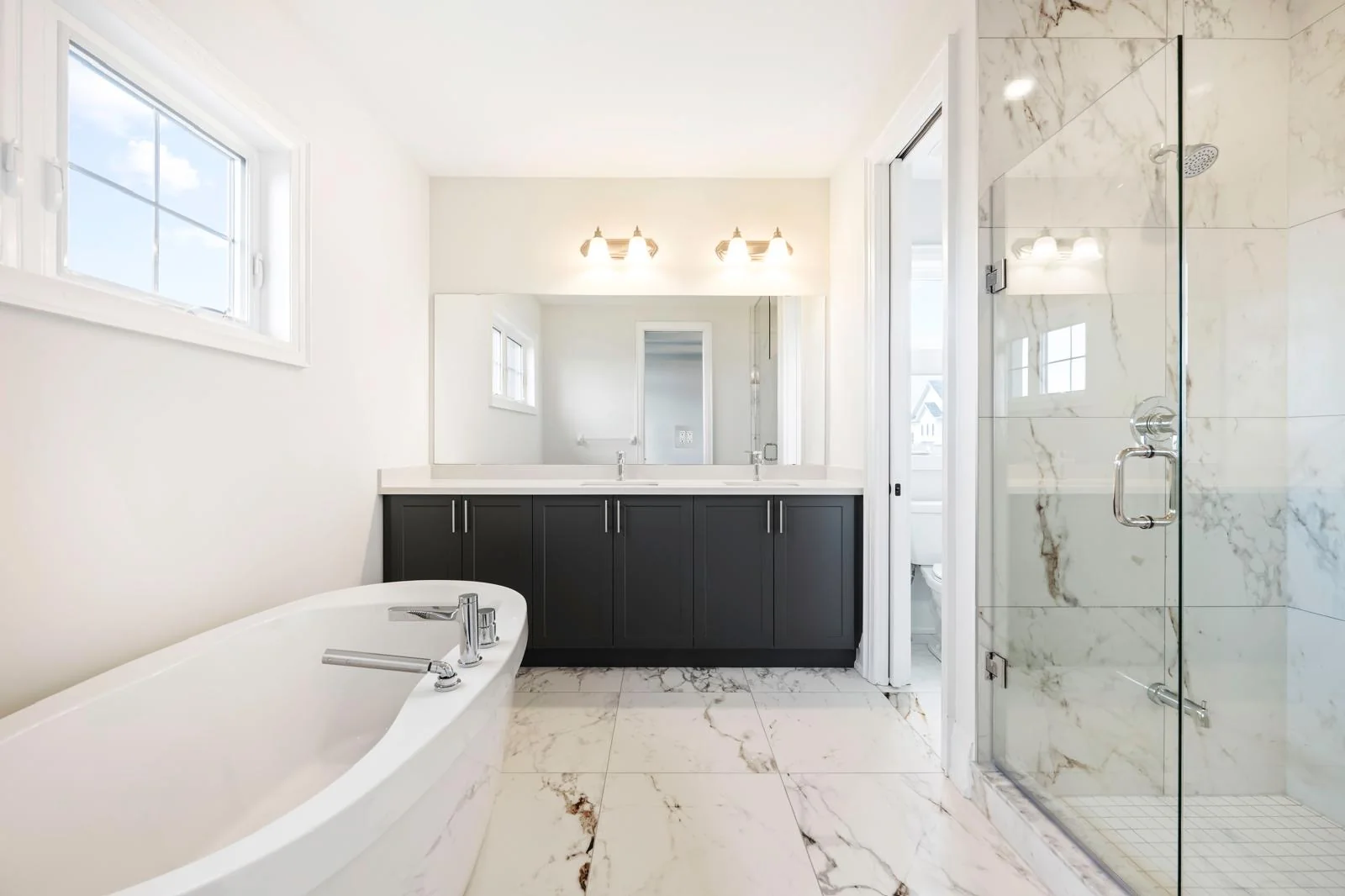 53 Holly Lane bathroom with bathtub, glass shower and double vanity