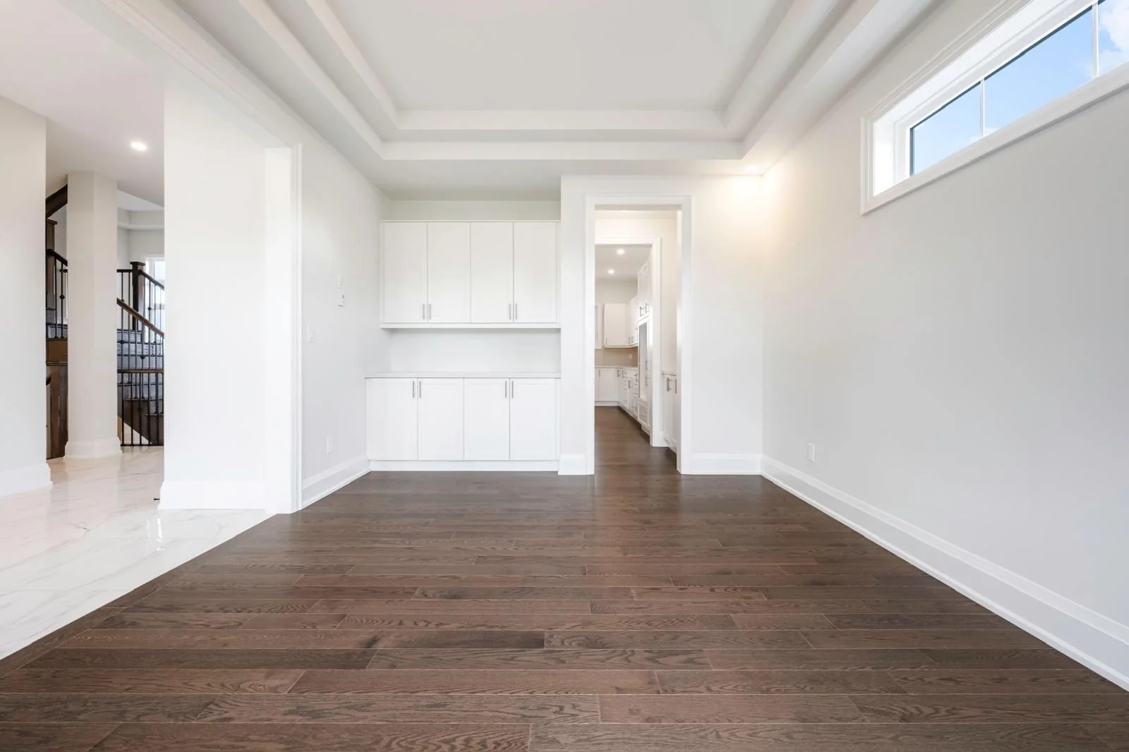 53 Holly Lane unfurnished dining room with tray ceiling and built-in cabinetry